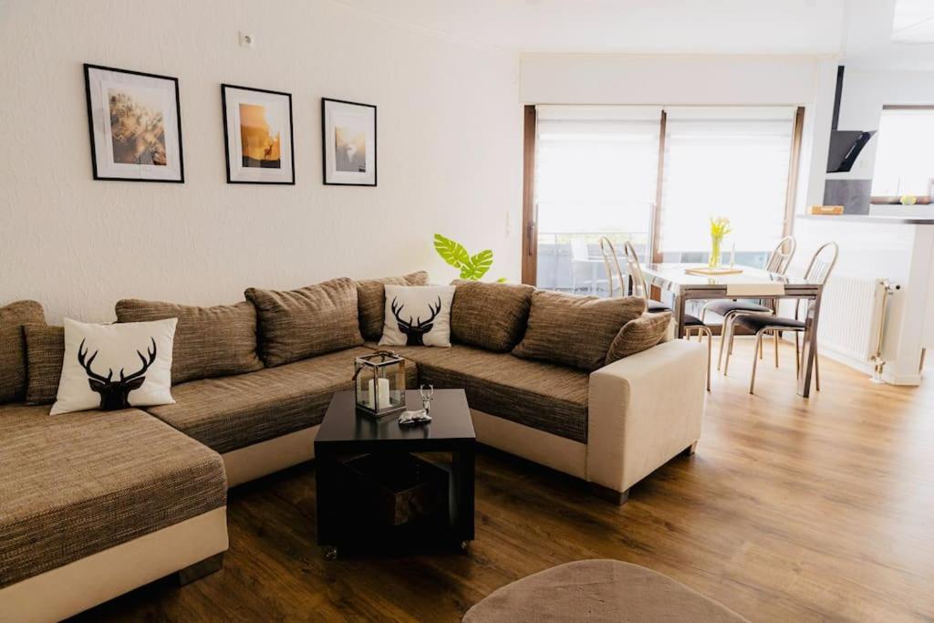 a living room with a couch and a table at Wohnung Hirschhöhe im Taunus in Neu-Anspach