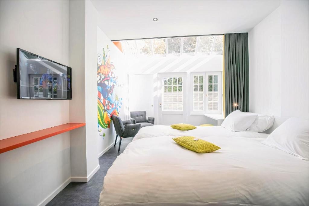 Postel nebo postele na pokoji v ubytování Hotel L'Esprit Sain