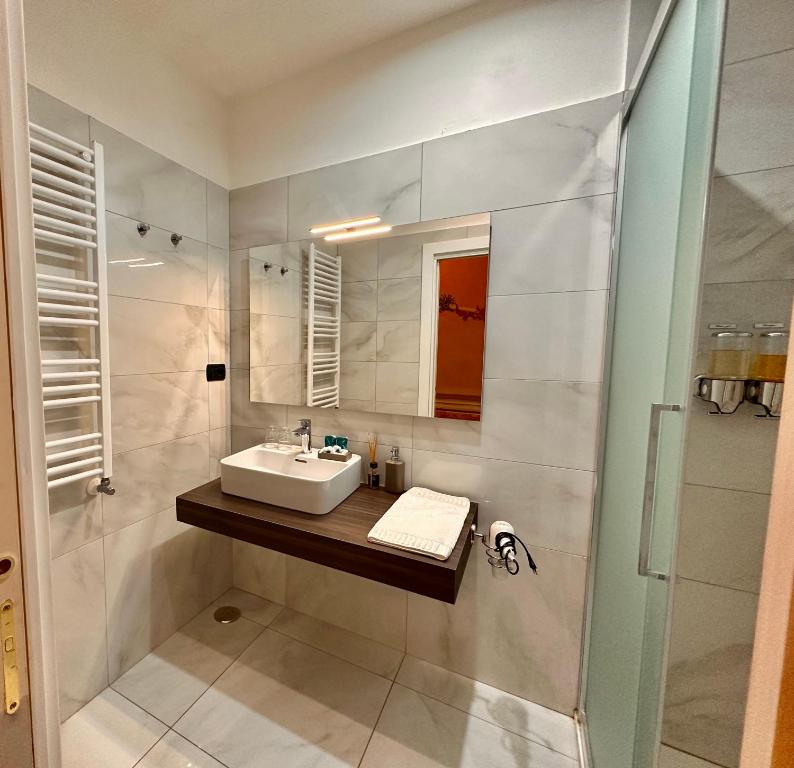 a white bathroom with a sink and a shower at Casa Santangelo Suites in Salerno