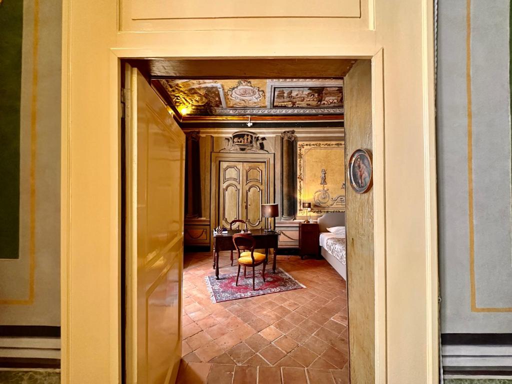 a hallway leading to a room with a table at Casa Santangelo Suites in Salerno