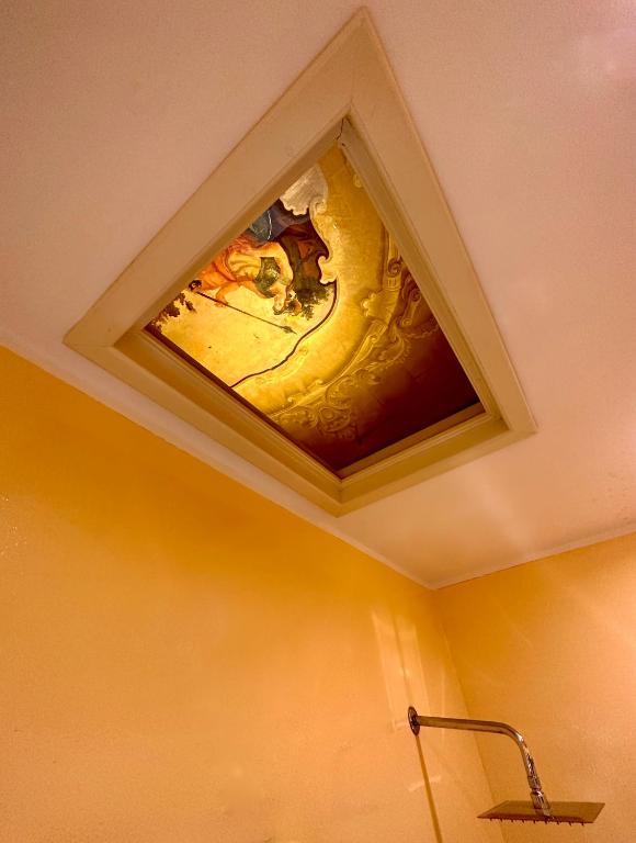 a painting on the ceiling of a bathroom at Casa Santangelo Suites in Salerno