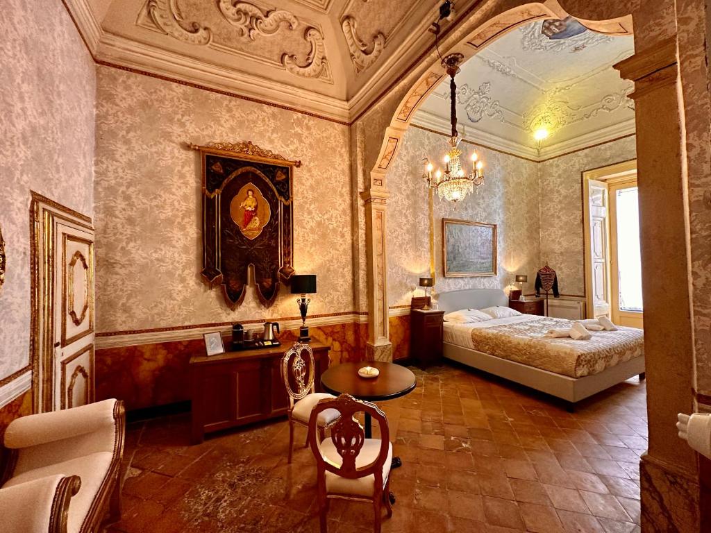 a bedroom with a bed and a table in it at Casa Santangelo Suites in Salerno