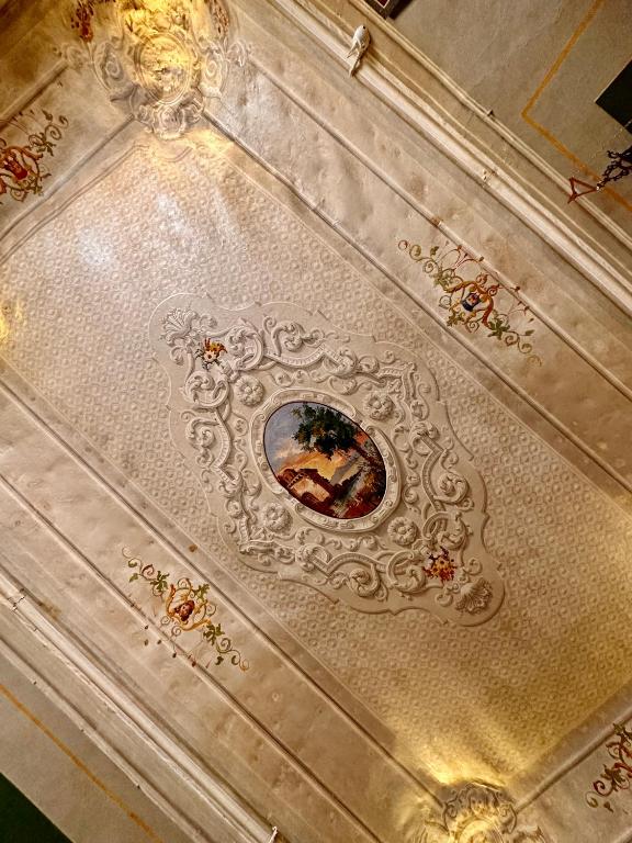 a white ceiling with a painting on it at Casa Santangelo Suites in Salerno
