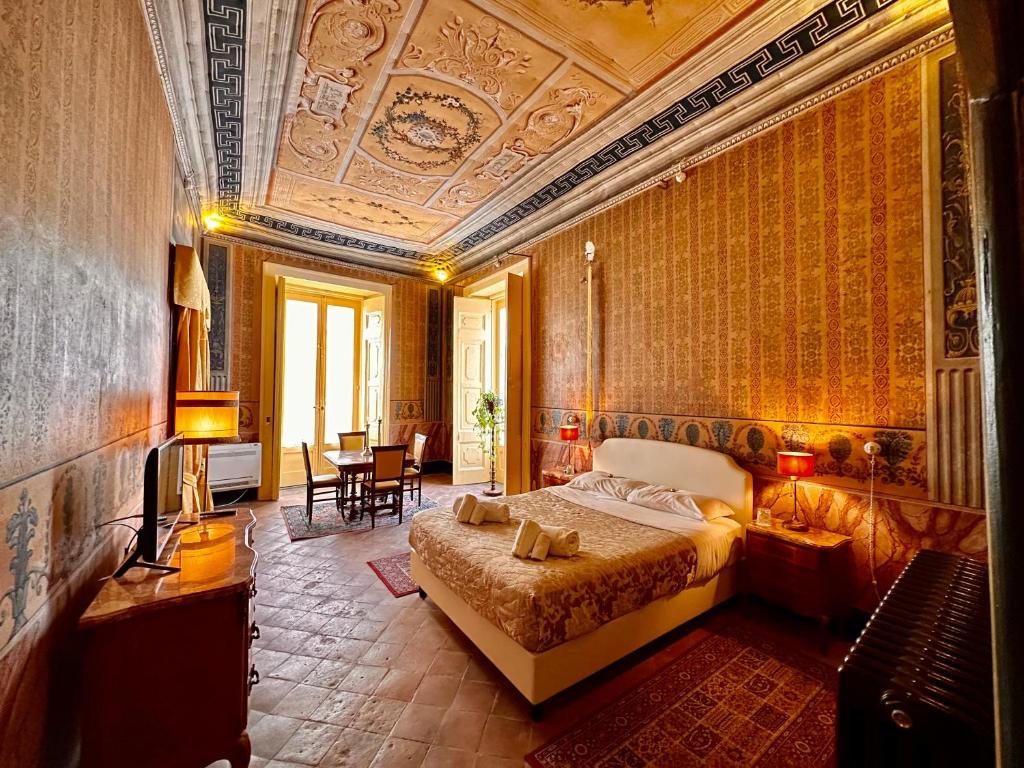 a bedroom with a bed and a coffered ceiling at Casa Santangelo Suites in Salerno