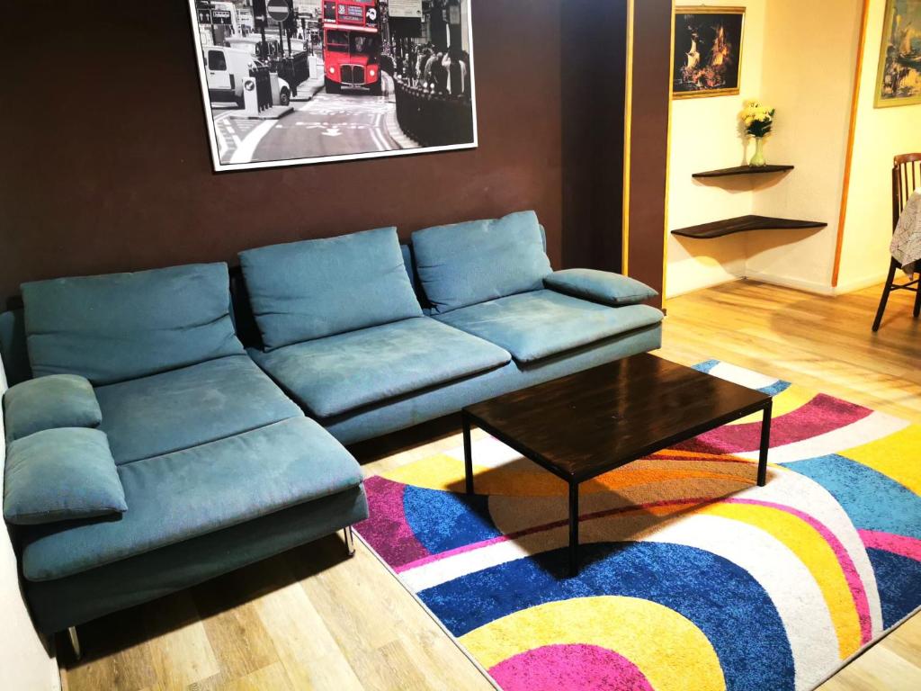 a living room with a blue couch and a coffee table at Apartamento a 5 minutos distancia de playa en Puerto de Sagunto -Full Apartment -120m2 in Puerto de Sagunto