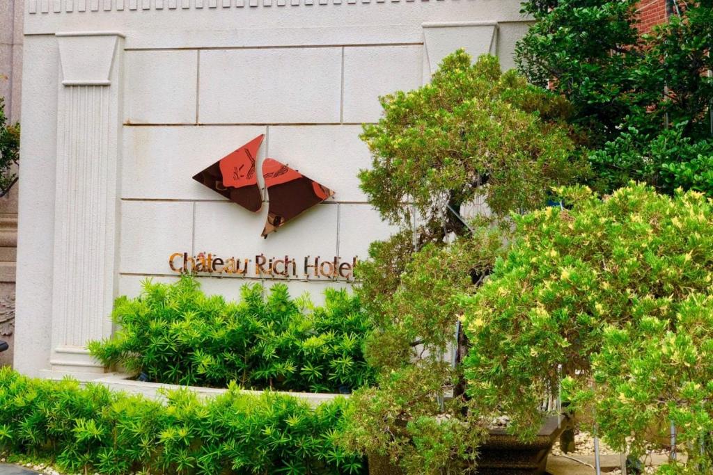 a red umbrella hanging on the side of a building at Chateau-Rich Hotel in Tainan