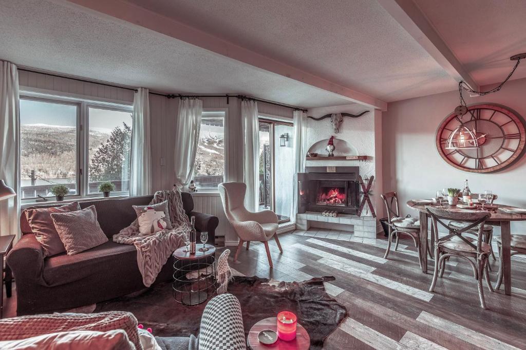 a living room with a couch and a fireplace at Amazing Lakemountain View 5min To Tremblant 491 in Mont-Tremblant
