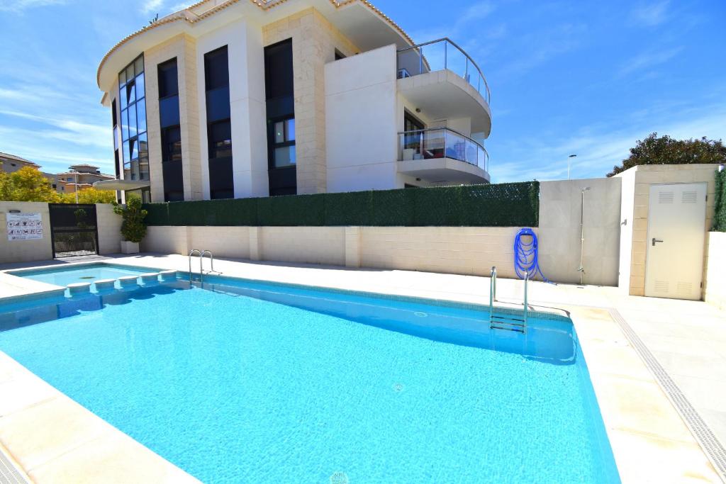 a swimming pool in front of a building at 5056 Apartamento Nuba Javea in Jávea