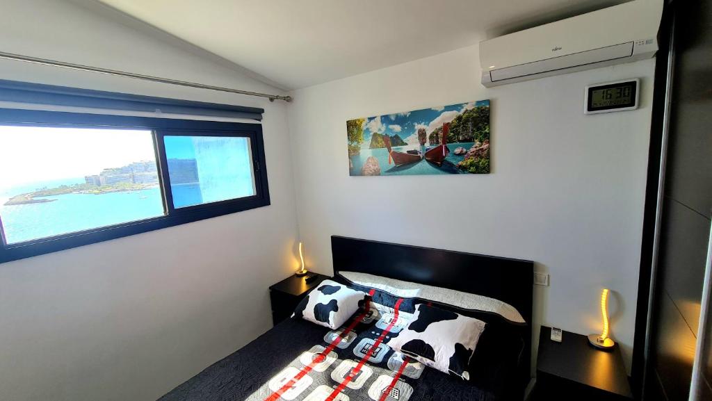 a bedroom with a bed with a cow pillow on it at DELUXE SeaView-SUNSETS !TRANSFE-R inc! POOL,2AirCond,2TV65",600Mb Dishwasher,,2 BEACHes,ANFI-view in Patalavaca