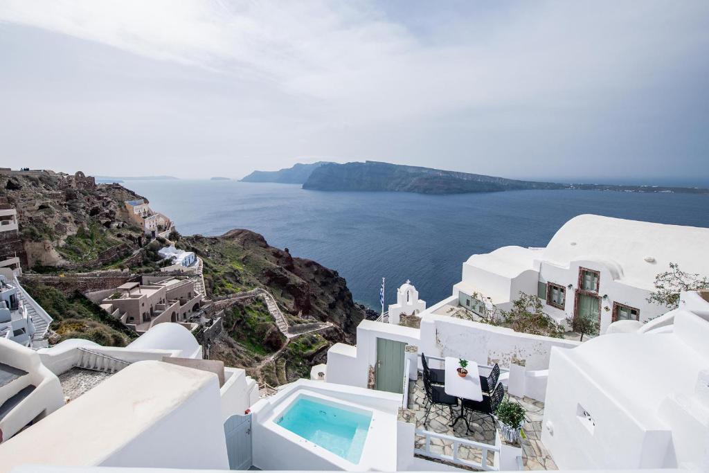 a view of the ocean from the side of a cliff at Ambi Villas Santorini in Oia