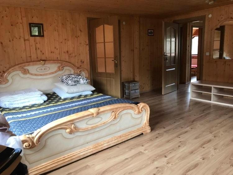 a large bed in a room with a wooden floor at Kvasy 838 in Kvasy