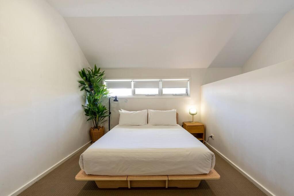 a bedroom with a bed and a window at Gawler Townhouses 1a in Gawler