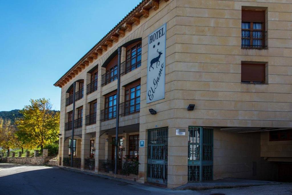 a building with a sign on the side of it at Hotel El Gamo in Tragacete