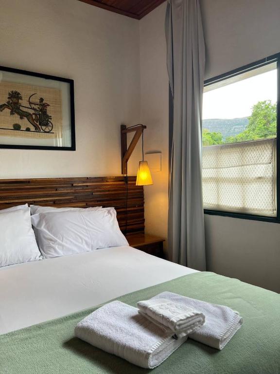 Postel nebo postele na pokoji v ubytování Cama e Café Tiradentes