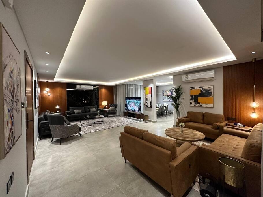 a living room with a couch and a table at ROSE RESIDENCE I Luxury 3BR Apartment I North Riyadh in Riyadh
