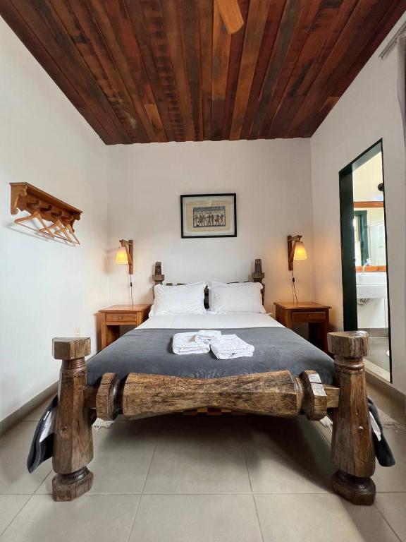 Postel nebo postele na pokoji v ubytování Cama e Café Tiradentes