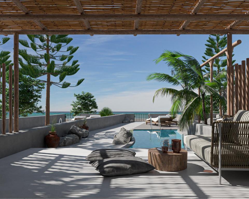 una piscina con vistas al océano en Oscar Beachfront Suites - Adults Only, en Perivolos