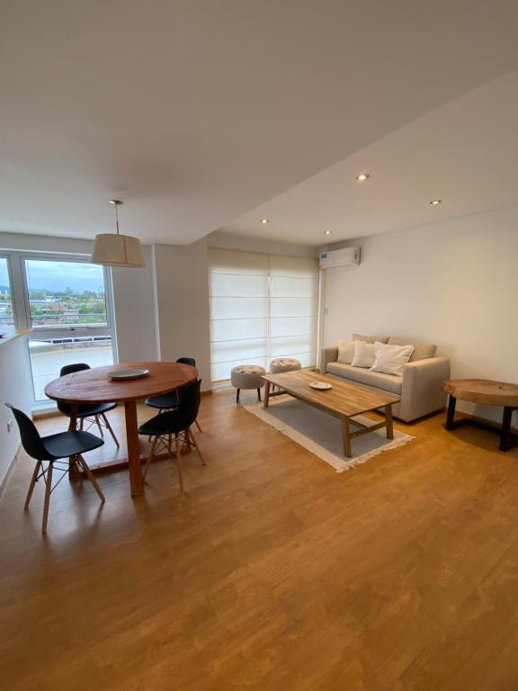 uma sala de estar com uma mesa e um sofá em Hermoso departamento de 2 habitaciones, en Salta Capital em Salta