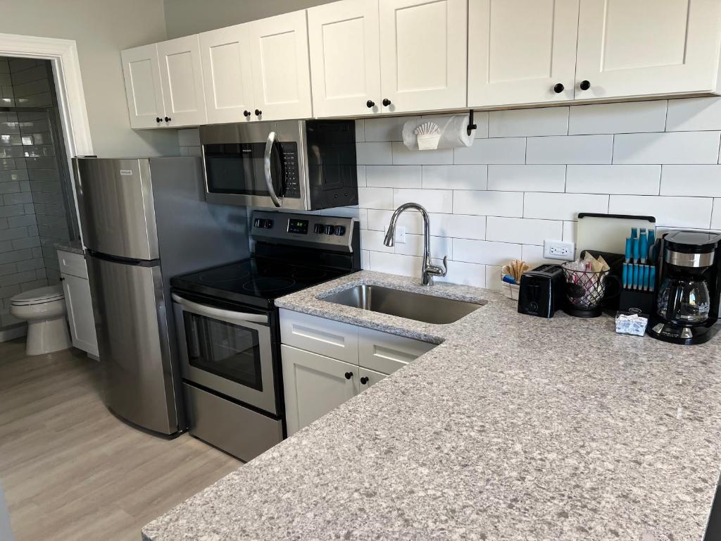 a kitchen with a sink and a refrigerator at Marco Island Lakeside Inn in Marco Island