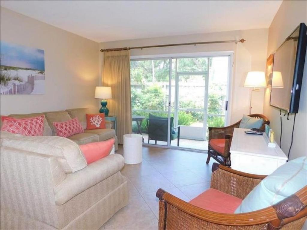 a living room with a couch and a tv at J15 lovely village area condo sleeps 6 comfy very nicely furnished screened in porch in Mallory Park