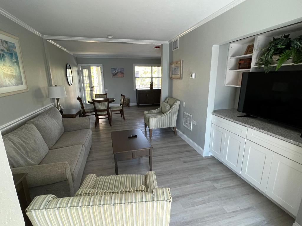 a living room with a couch and a flat screen tv at Marco Island Lakeside Inn in Marco Island