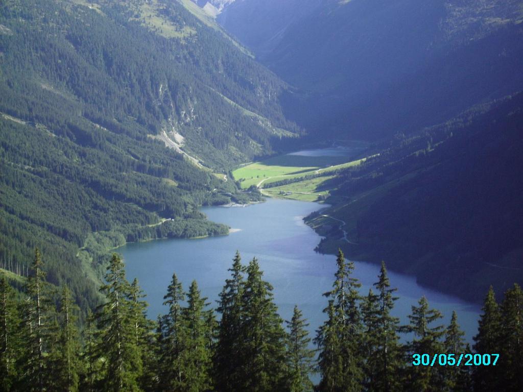 a view of a river in a valley with trees at Chalet Anna Appartment in Uttendorf