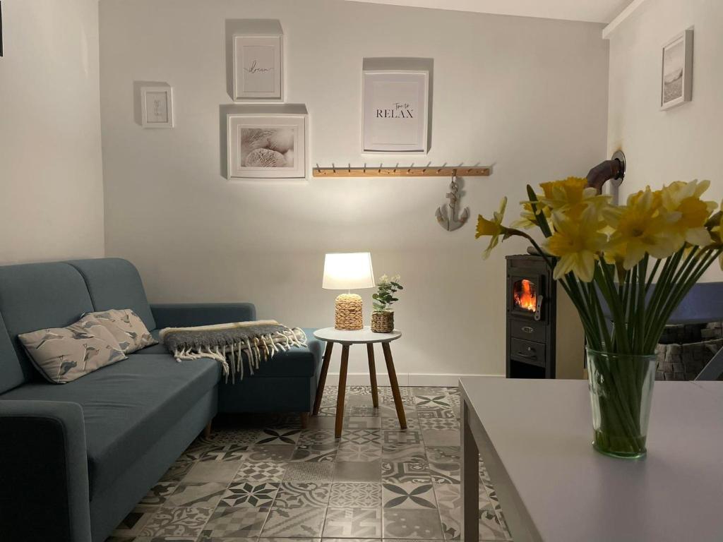 a living room with a couch and a table at Apartament Letni Wiatr in Przewłoka