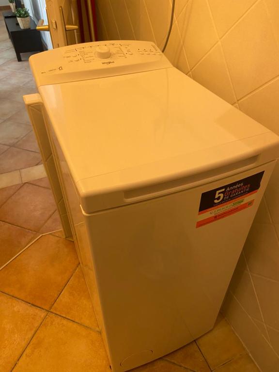 a white refrigerator is sitting in a room at Corso Home- central apartment in Menton in Menton