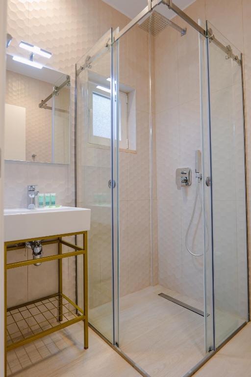 a bathroom with a shower and a sink at Otto Hotel in Ksamil