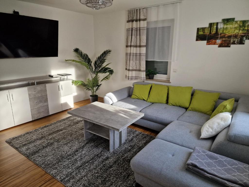 a living room with a couch and a table at Ferienwohnungen Waldina in Siegen