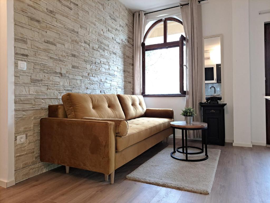 a living room with a couch and a brick wall at Apartment Karlo in Sali