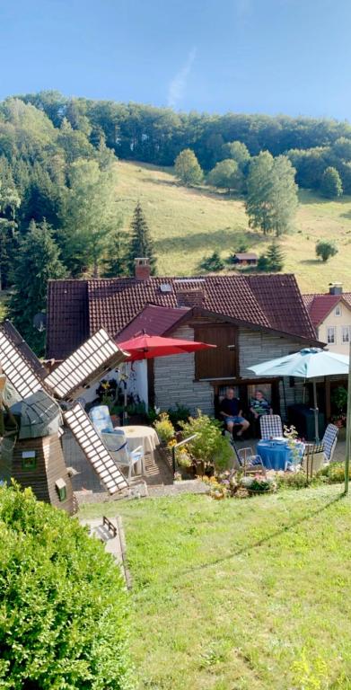 a house with a patio with a table and chairs at Haus Wiesenblick in Walkenried