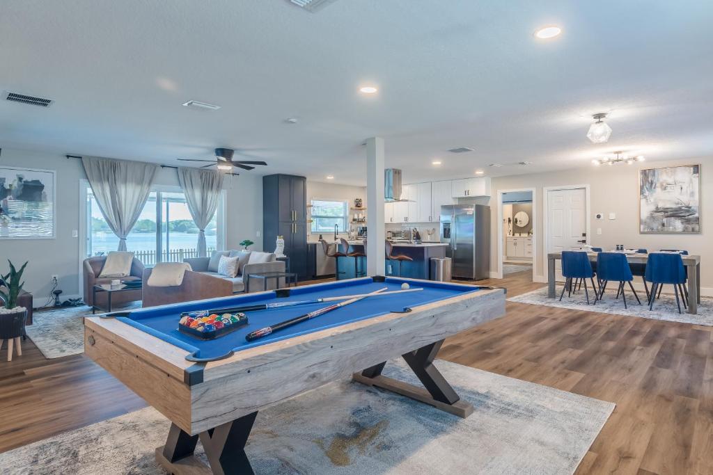 a pool table in the middle of a living room at Lake House Retreat Near Downtown, Disney, Universal Studios and Airport in Orlando