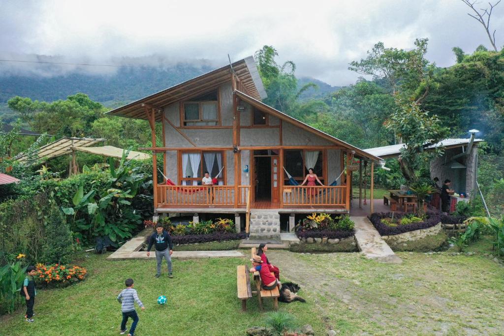 a group of people standing in front of a house at La Casa en el Aire Mindo in Mindo