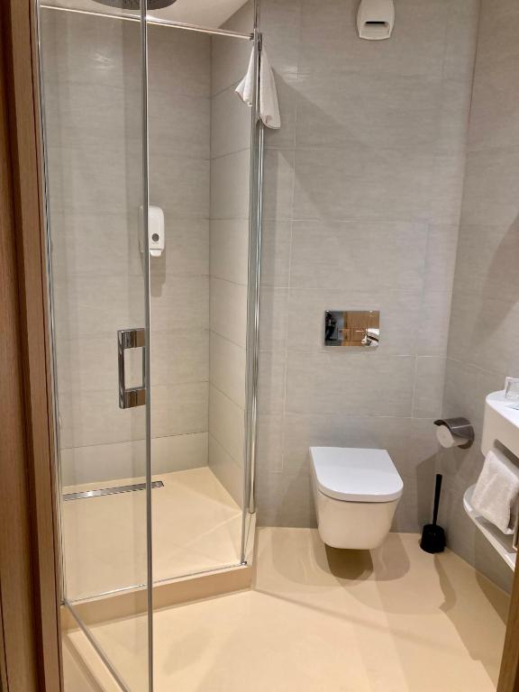 a bathroom with a shower and a toilet at SoBlue Hôtel in Antibes