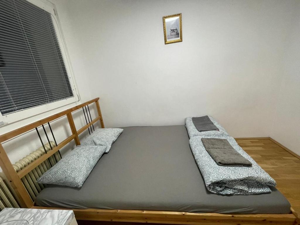a bedroom with two beds and a window at Nice rooftop hostel in Vienna