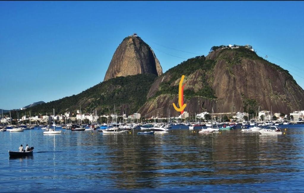 un grupo de barcos en un puerto con dos montañas en Urca Maravilhosa! Venha viver esse sonho UrCaRioCa !, en Río de Janeiro