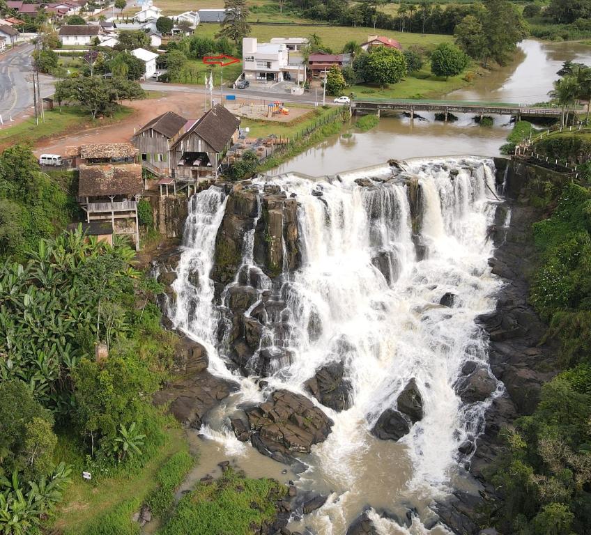 an aerial view of a waterfall in a village at Pousada Salto Donner in Rio Forcação