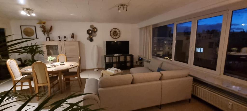 a living room with a couch and a table at SUPERB APPARTEMENT WITH 3 BED ROOMS IN ANTWERPEN in Antwerp