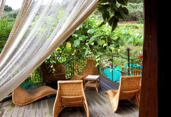 a porch with wicker chairs and a table and chairs at Hotel Marina in Monterosso al Mare