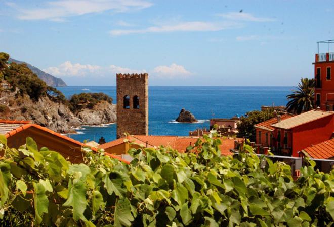 a building with a tower in the middle of the ocean at Hotel Marina in Monterosso al Mare