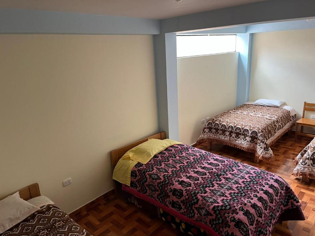 Postel nebo postele na pokoji v ubytování Hospedaje Catalina