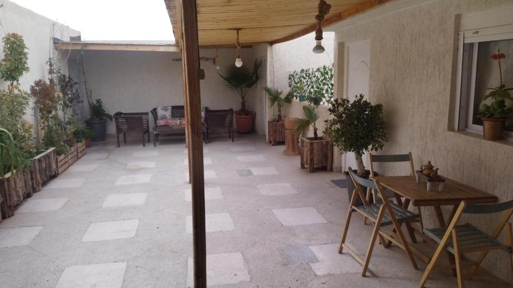 an outdoor patio with a table and chairs at شقة المنظر الجميل in Midelt