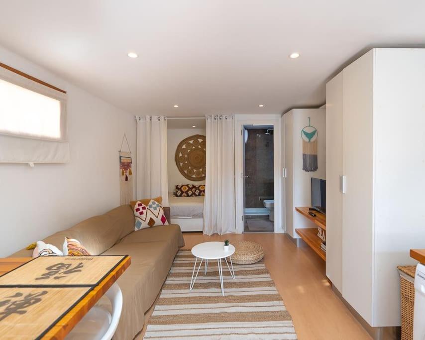 a living room with a couch and a table at Tiny House By Casa Maui in Corralejo