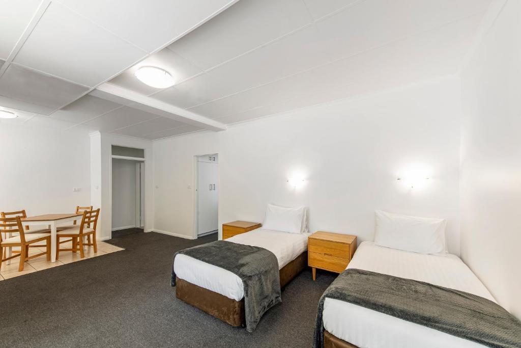Postel nebo postele na pokoji v ubytování Econo Lodge East Adelaide
