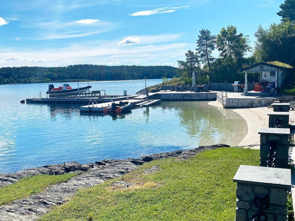 a group of boats docked at a dock on a lake at Holiday home NESØYA in Sandvika