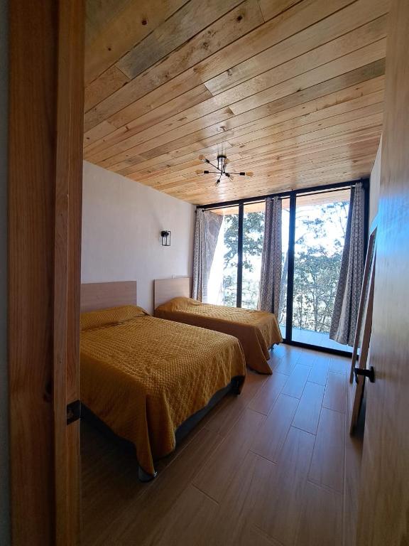 Postel nebo postele na pokoji v ubytování Cabaña La Finca Mazamitla