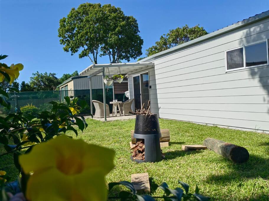 a backyard of a house with a patio and a house at Lovely Hidden Gem in Redcliffe in Redcliffe