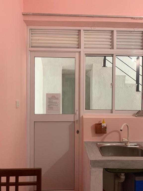 a kitchen with a glass door and a sink at Araliya Suite in Nugegoda