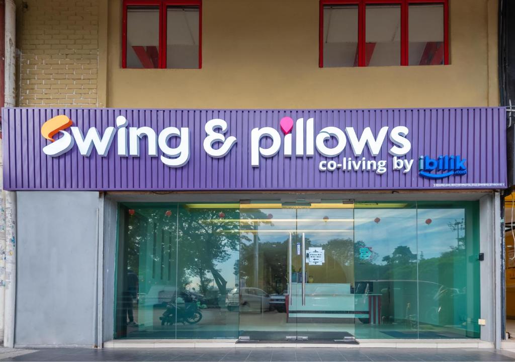 a purple sign for a living and pillows store at Swing & Pillows - PJ SS2 in Petaling Jaya